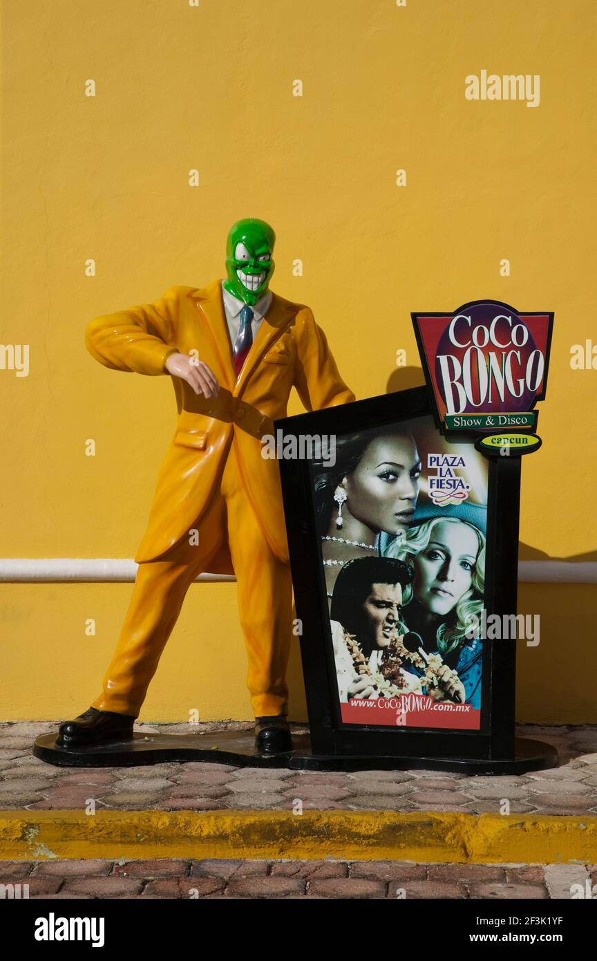 The Mask standing by an advert for Cocobongo's Show and Disco, Cancun,  Mexico Stock Photo - Alamy