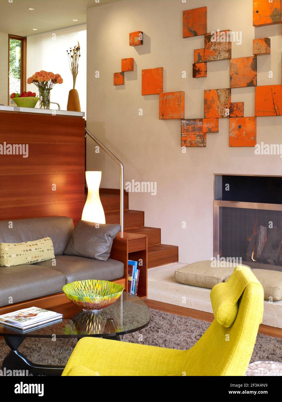 Split level living room with orange canvas art display in Odyssey House, Carmel, California, USA. Stock Photo