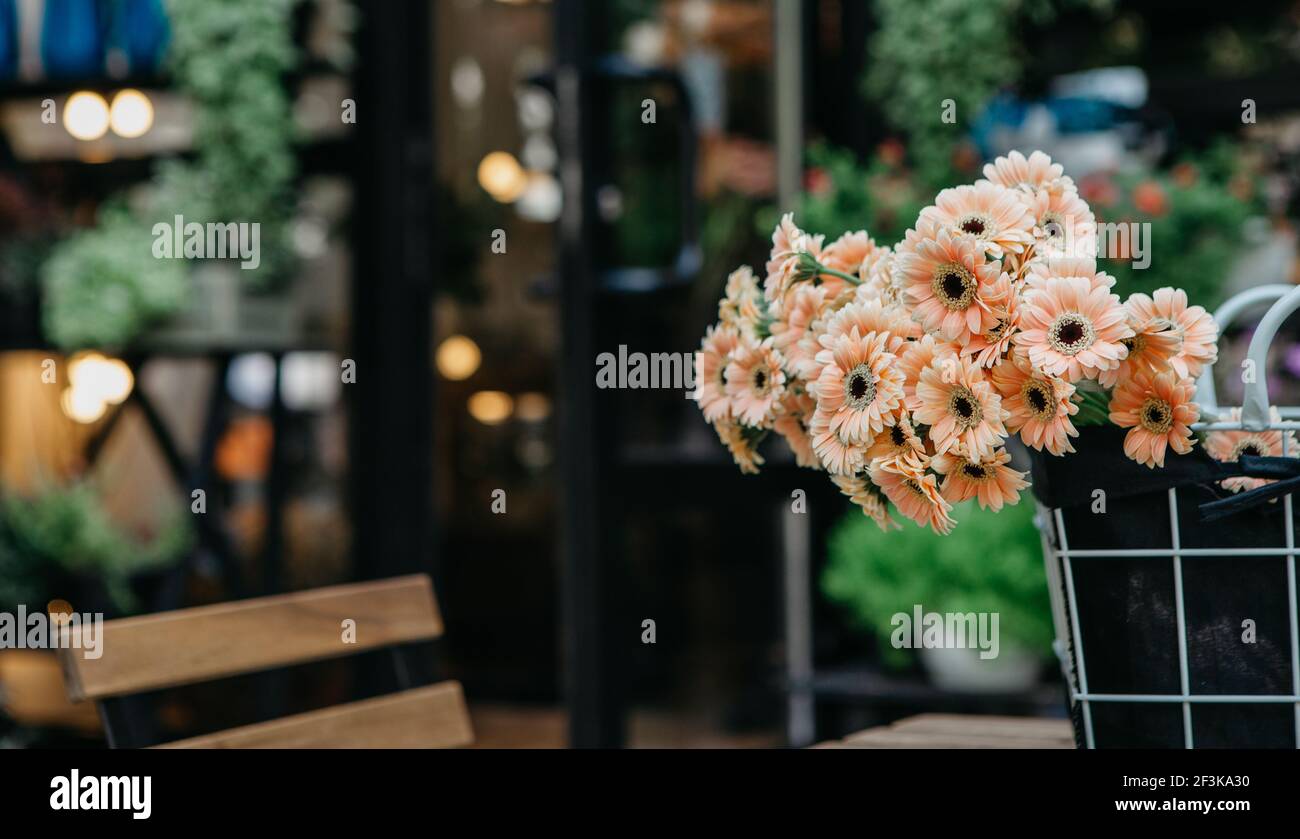 Cozy rustic vintage style in flower studio and organic cafe, outdoor interior, reopening after covid-19 pandemic Stock Photo