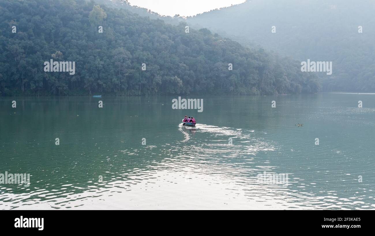 Pokhara, Nepal - November 20, 2015: Tourists rowing on a boat across Phewa lake Stock Photo