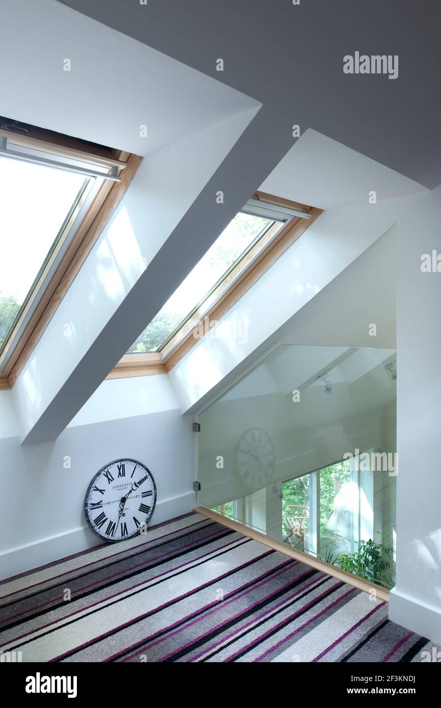 Master bedroom velux windows and roof cut out above living room Stock ...
