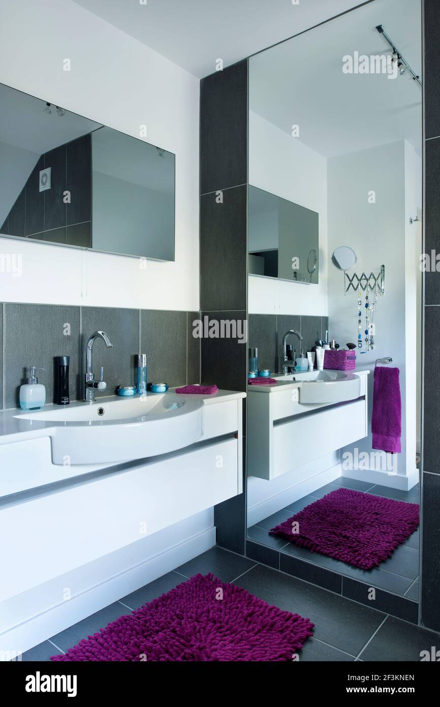 Master bedroom en suite bathroom reflected in full lenght mirror Stock Photo