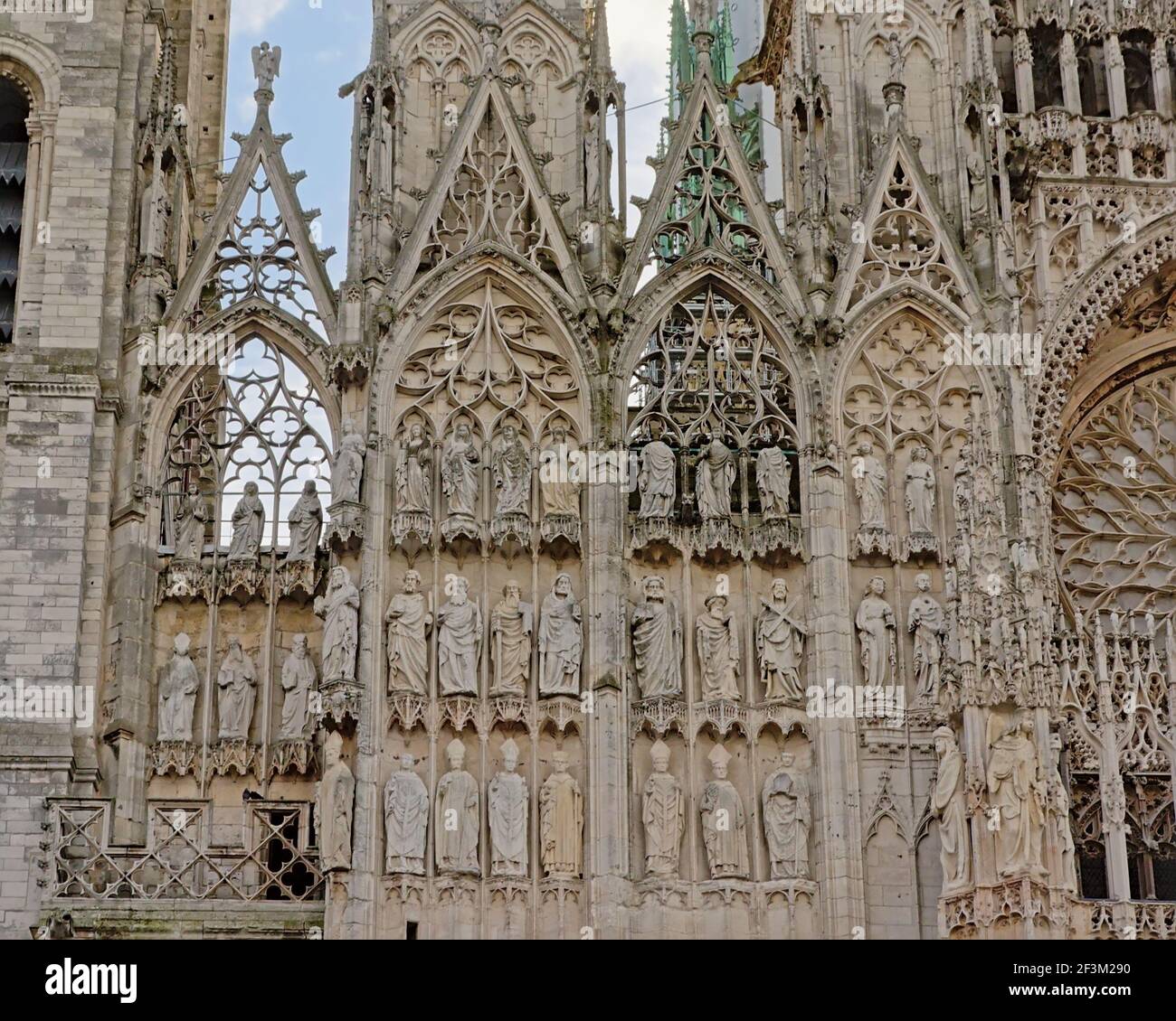 Architecture detail of the ornate gothic cathedral of Rouen, France, with statues of saints ...