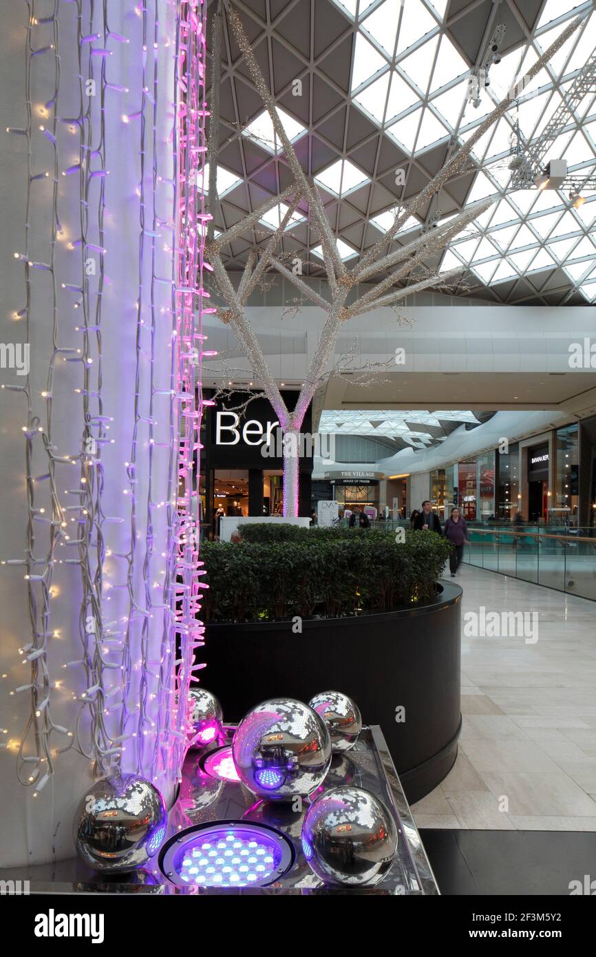 Shopping mall interior with structural "trees" festooned with coloured