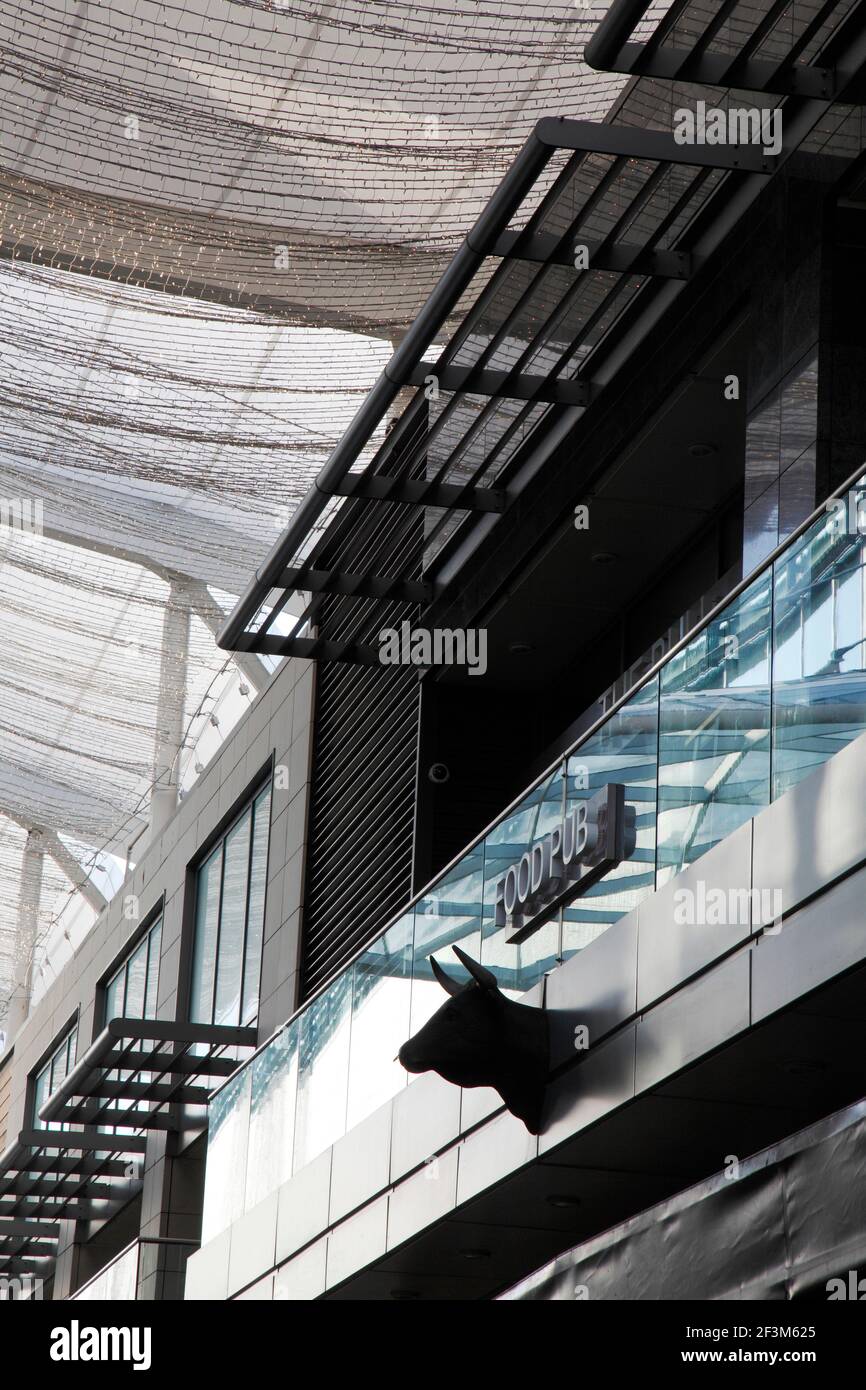 Bull's head on facade of restaurant building beneath canopies festooned