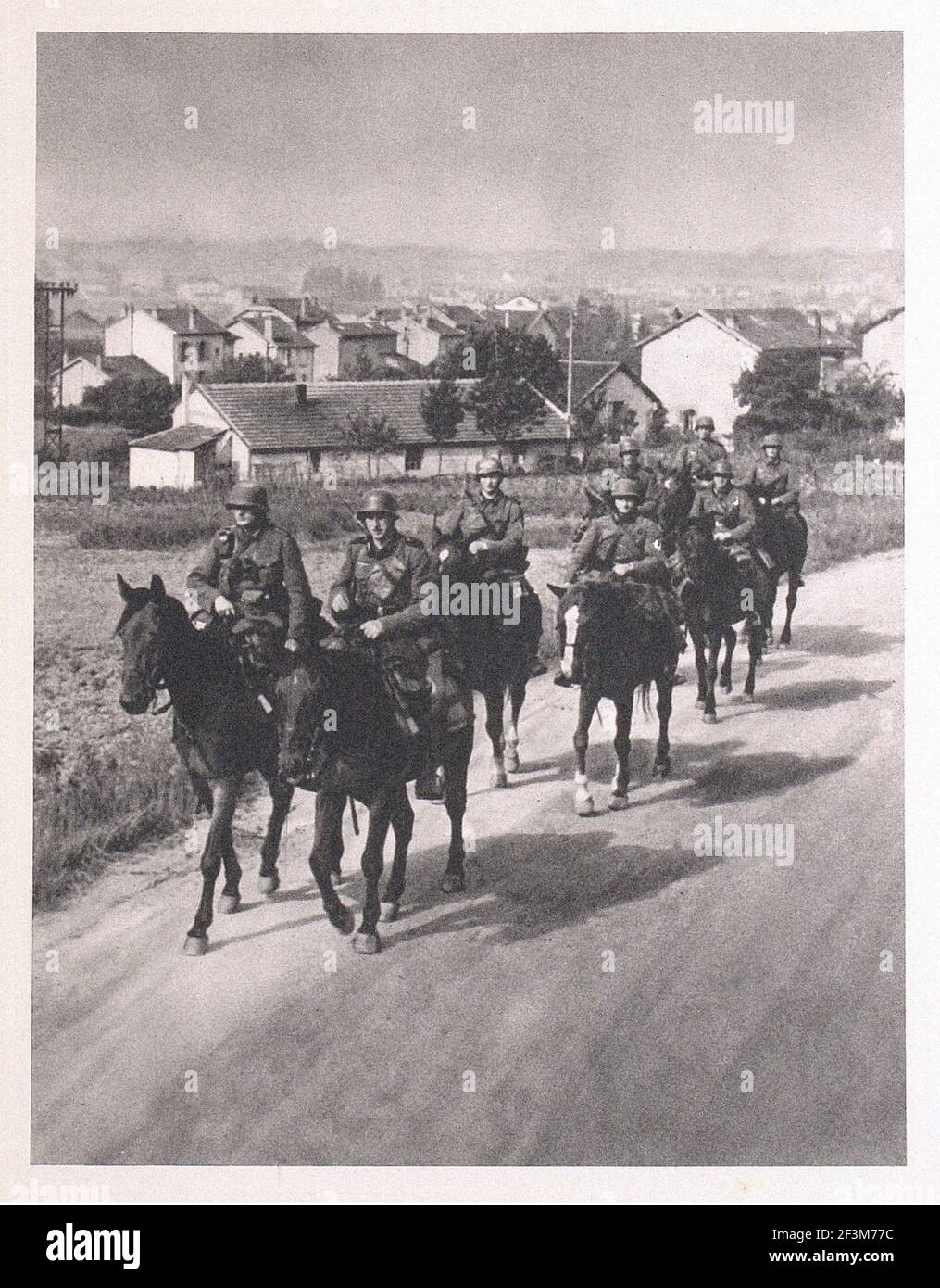 World War II period from German propaganda news. Battle of France. German patrol in occupied France. 1940 Stock Photo
