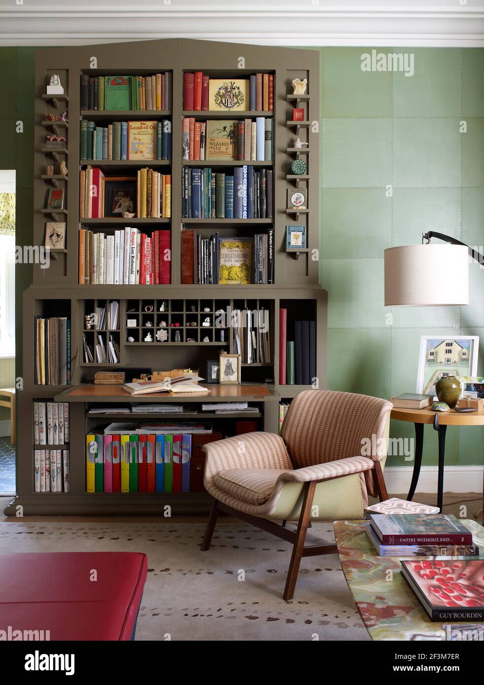 Bookshelf and armchair in residential home, UK Stock Photo Alamy