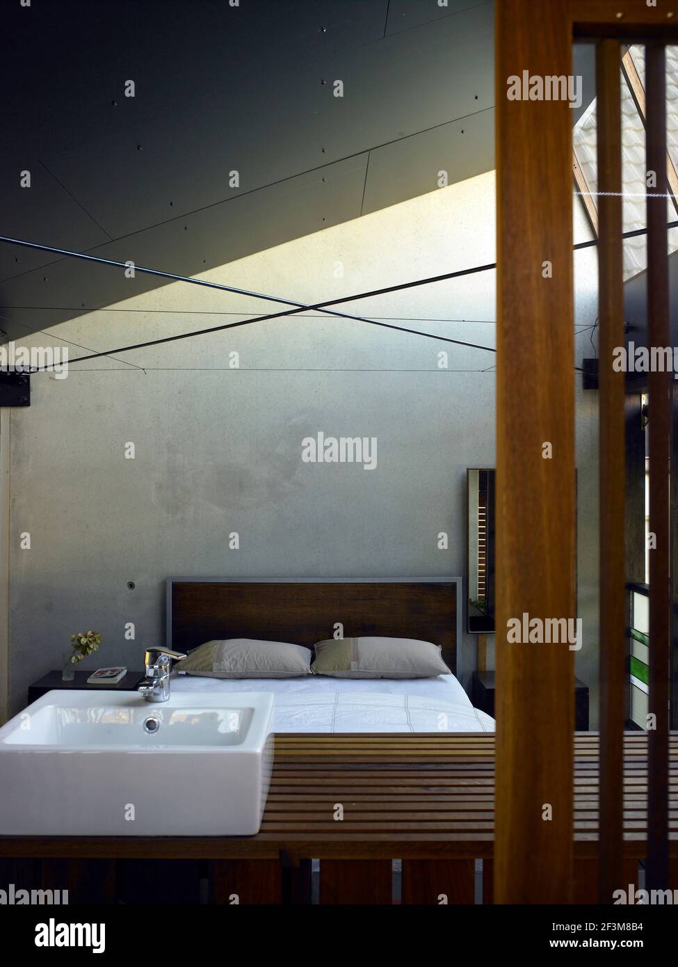 Bedroom with sloping roof, skylight and wash basin in residential house,  Queensland, Australia Stock Photo - Alamy