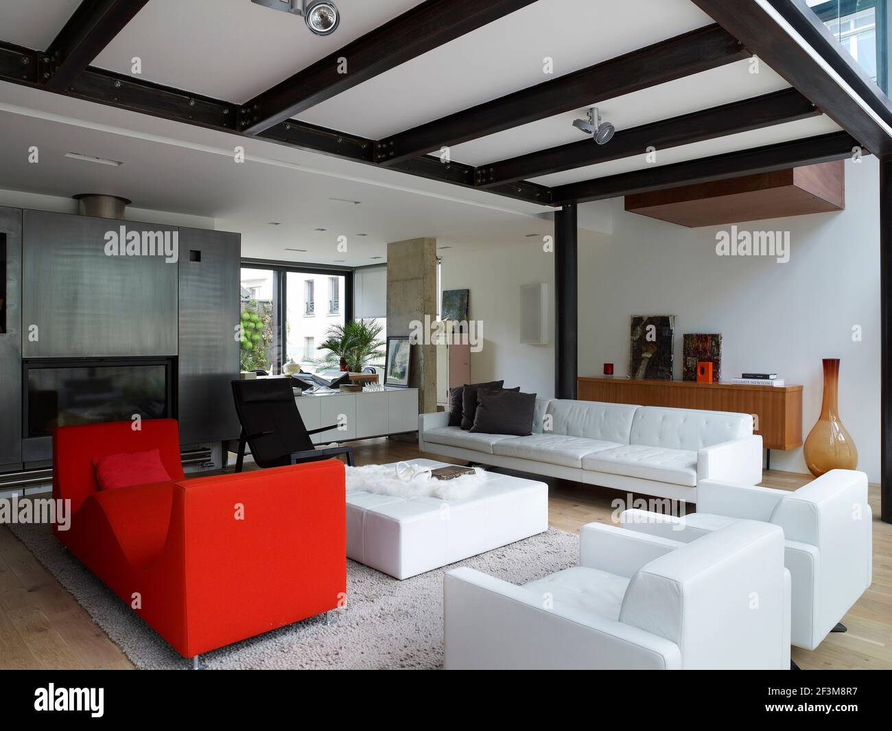 Open plan living area with modern sofas and chairs in French