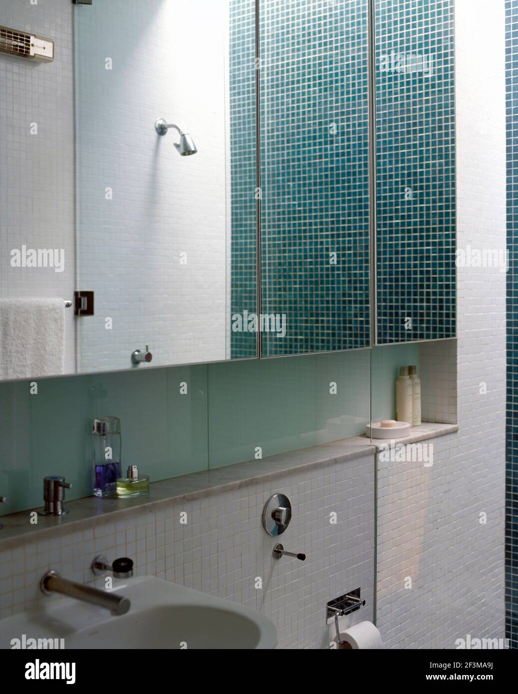 Mosaic tiled bathroom with sink and mirrored units, USA Stock Photo Alamy