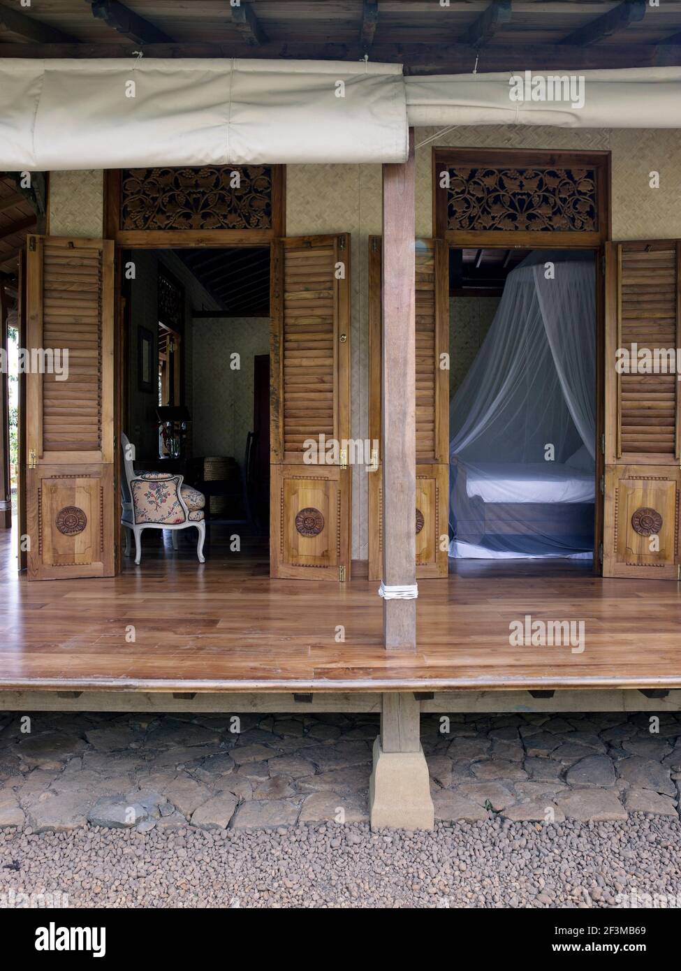 Two doorways with wooden shutters leading from living area and bedroom
