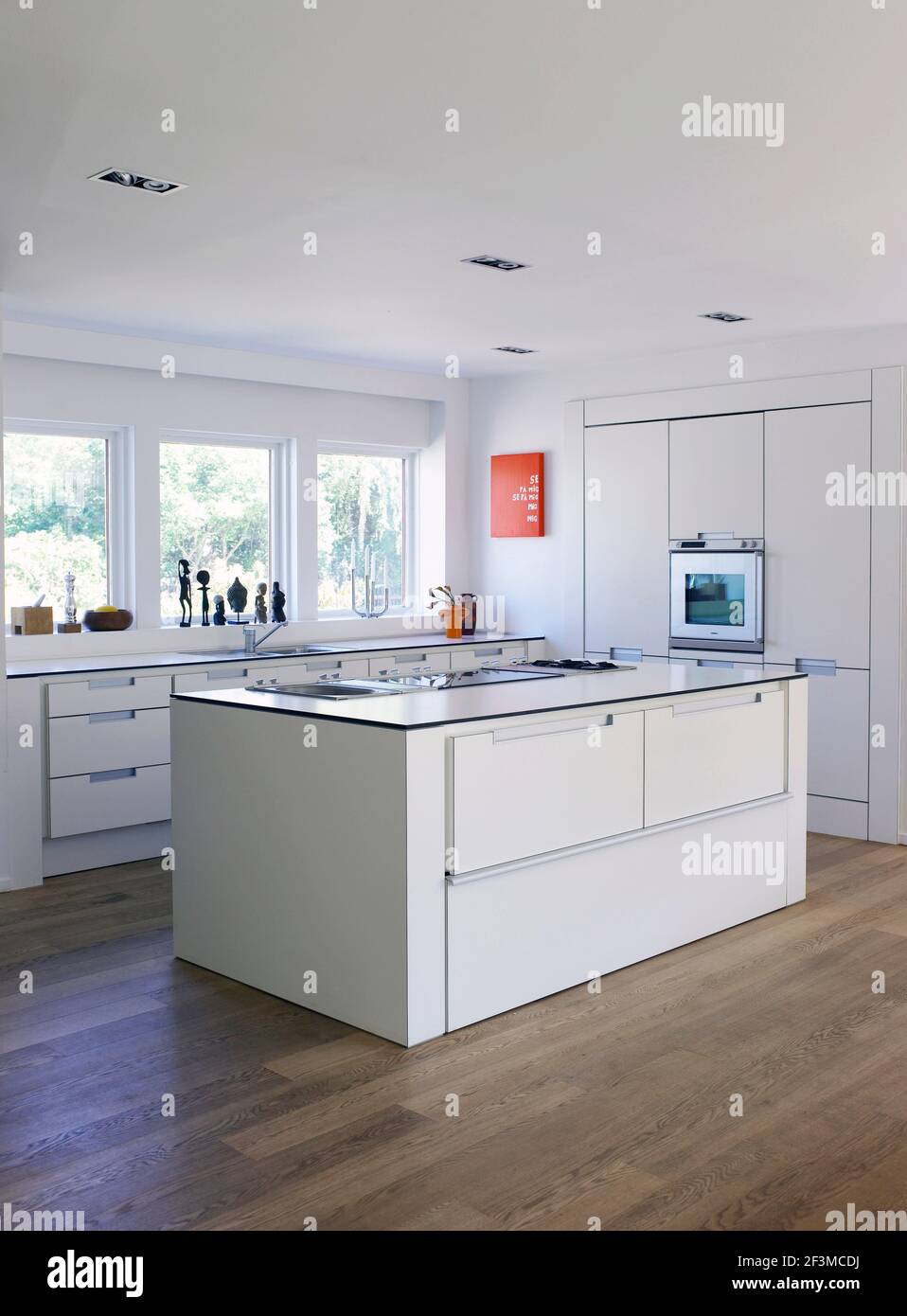 White open plan kitchen in residential house, Denmark. Stock Photo