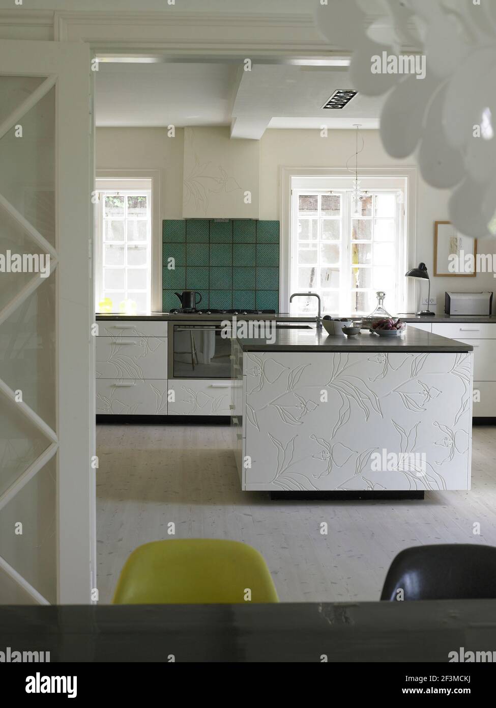 Kitchen island and uncurtained windows in residential home, Denmark Stock Photo