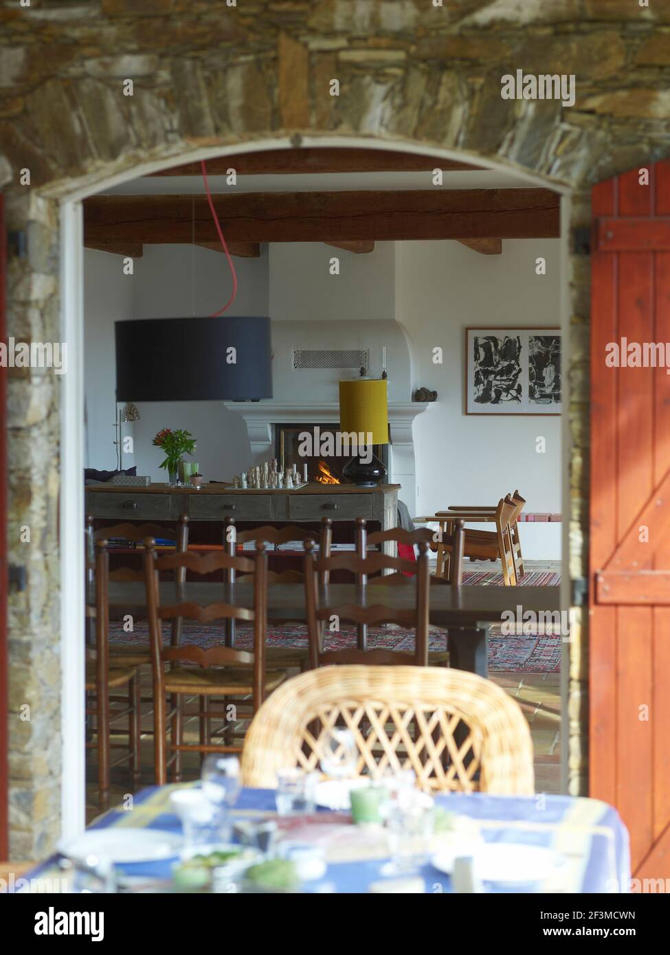 A view through from outdoor arched courtyard doorway to interior dining