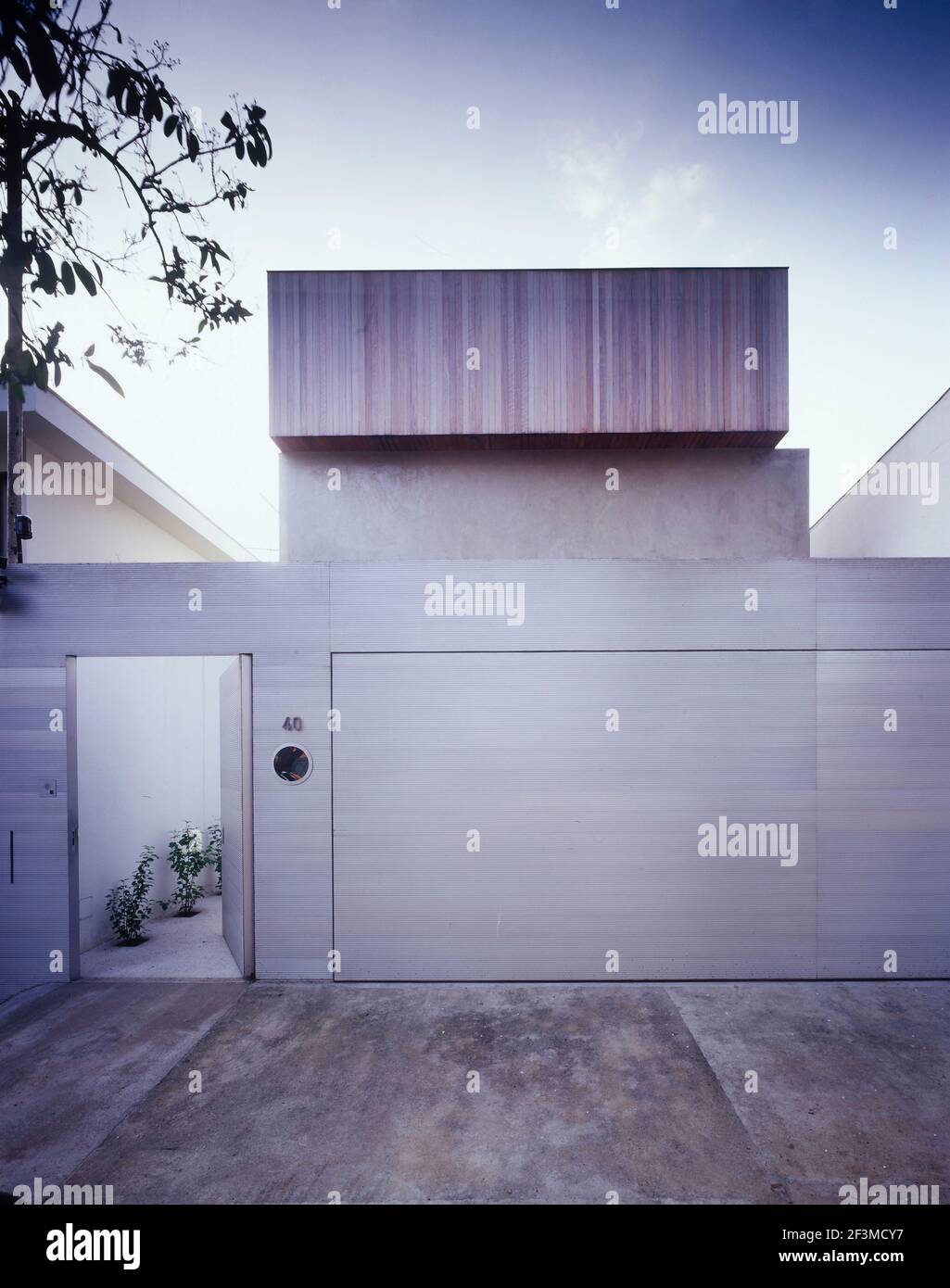 Open door and garage exterior with concrete driveway of newbuild house, Brazil Stock Photo