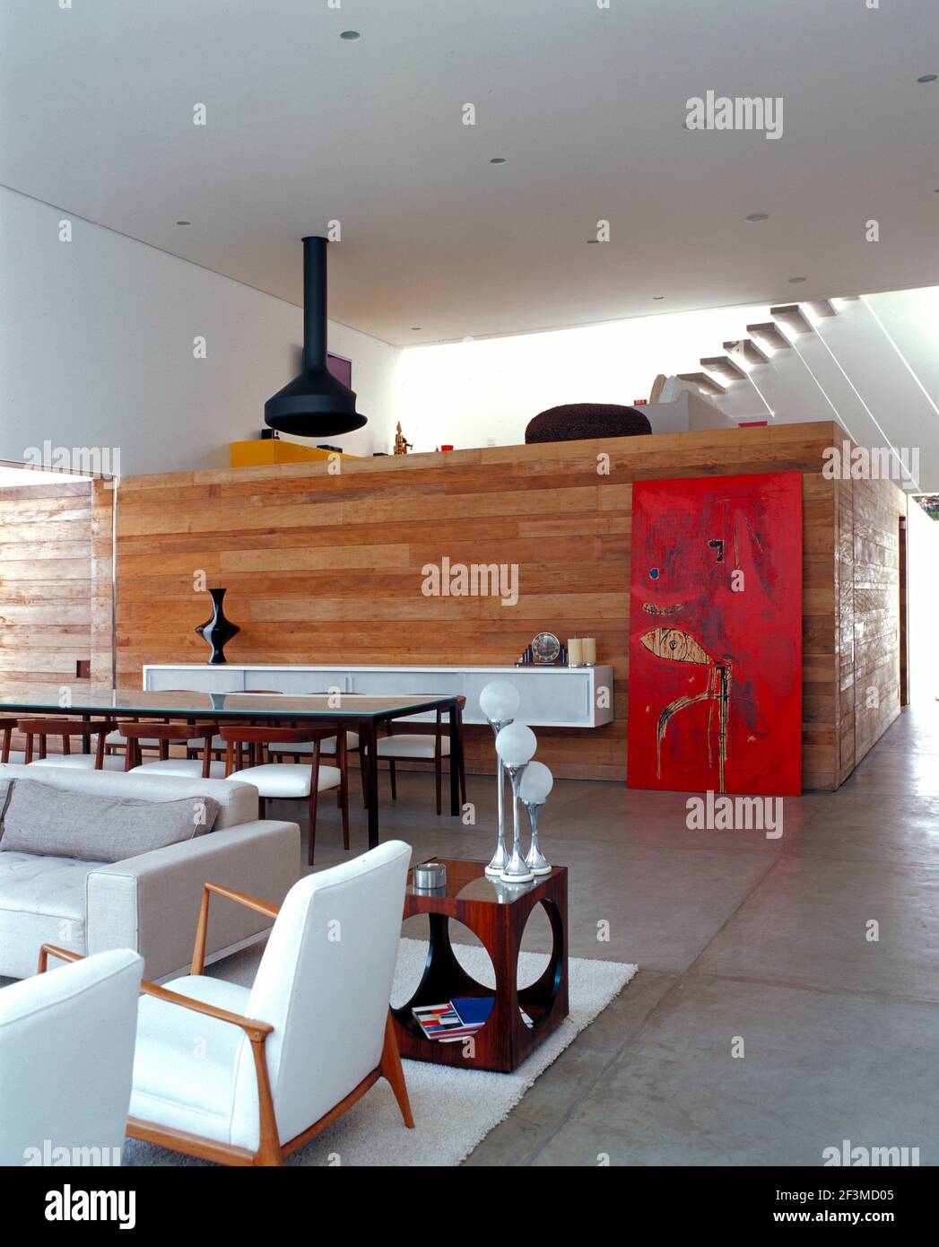 View of Open plan living room with wood clad mezzanine area in residential ...