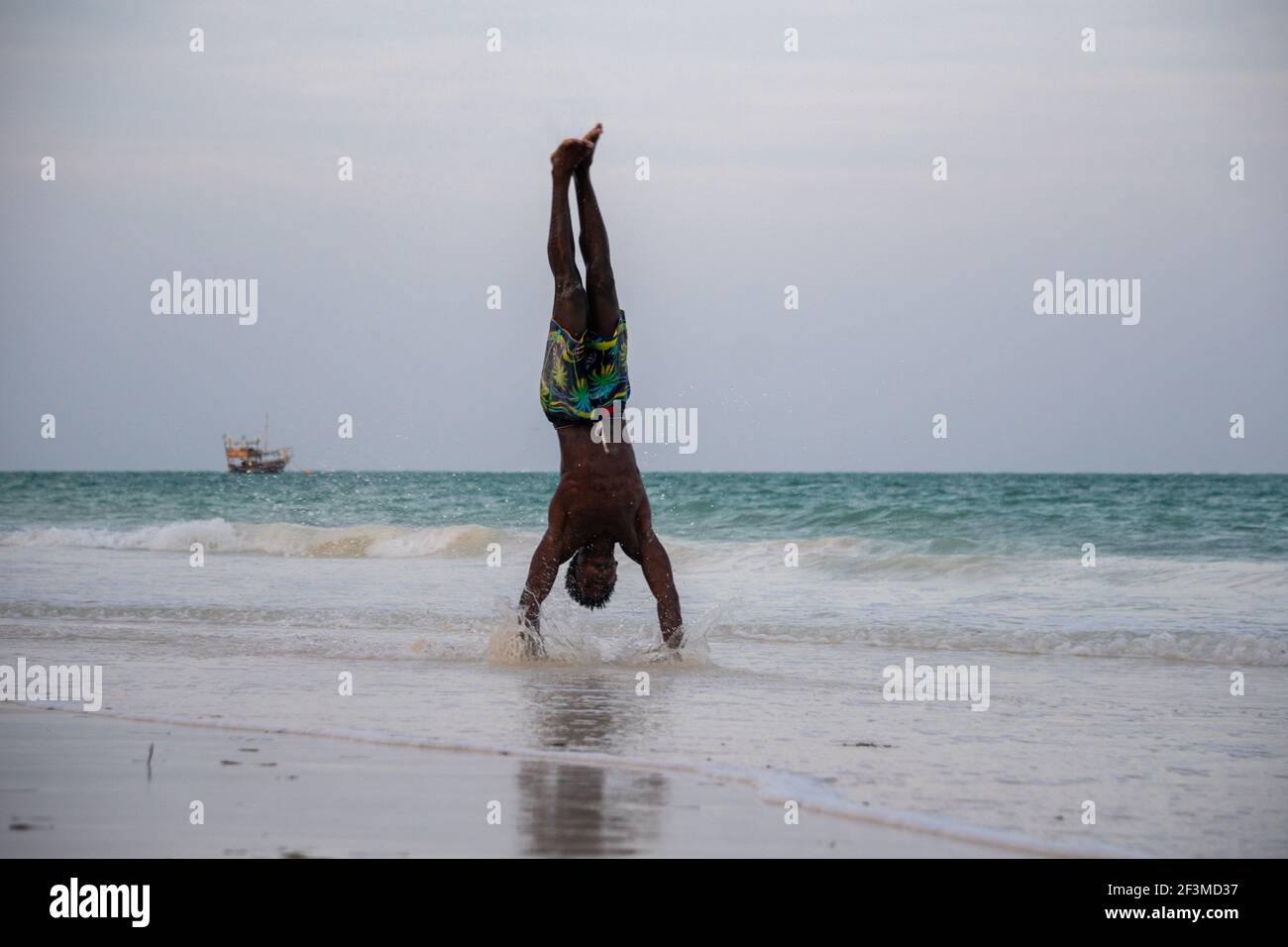 Young Attractive Muscular and Strong Athletic Black African Man at the White Sand Beach Training Body Calisthenics Stock Photo