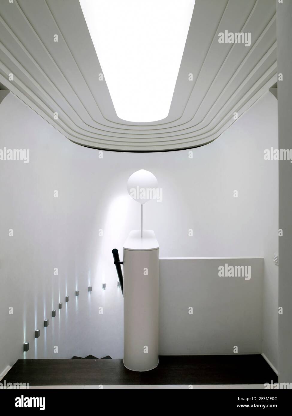 Futuristic ceiling and wall lighting above interior stairwell in residential house, Russia. Stock Photo