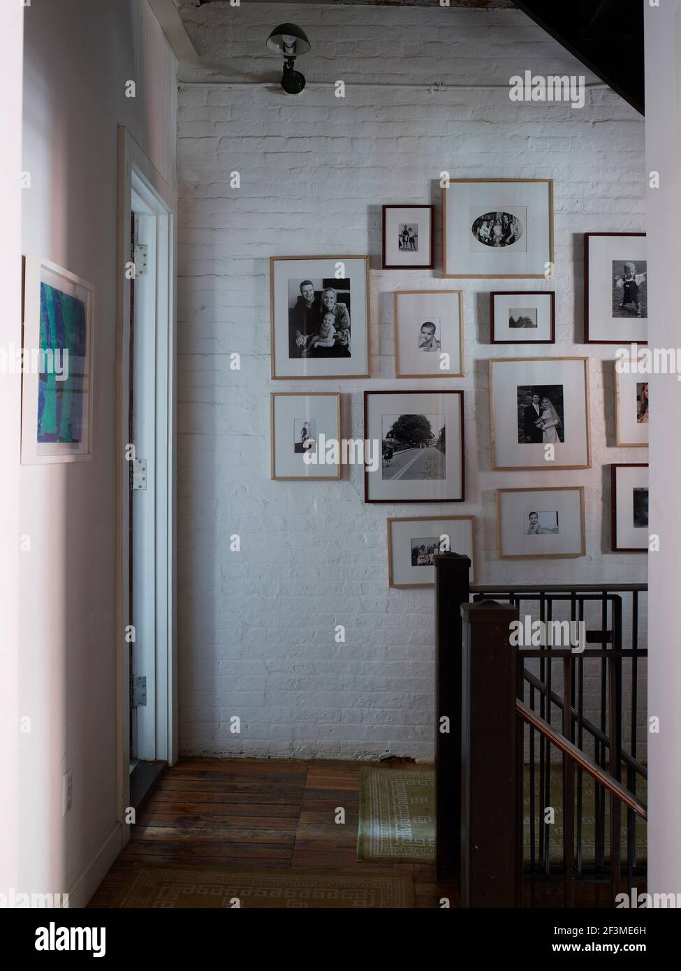 Collection of framed photo mounted on interior painted brick wall with ...