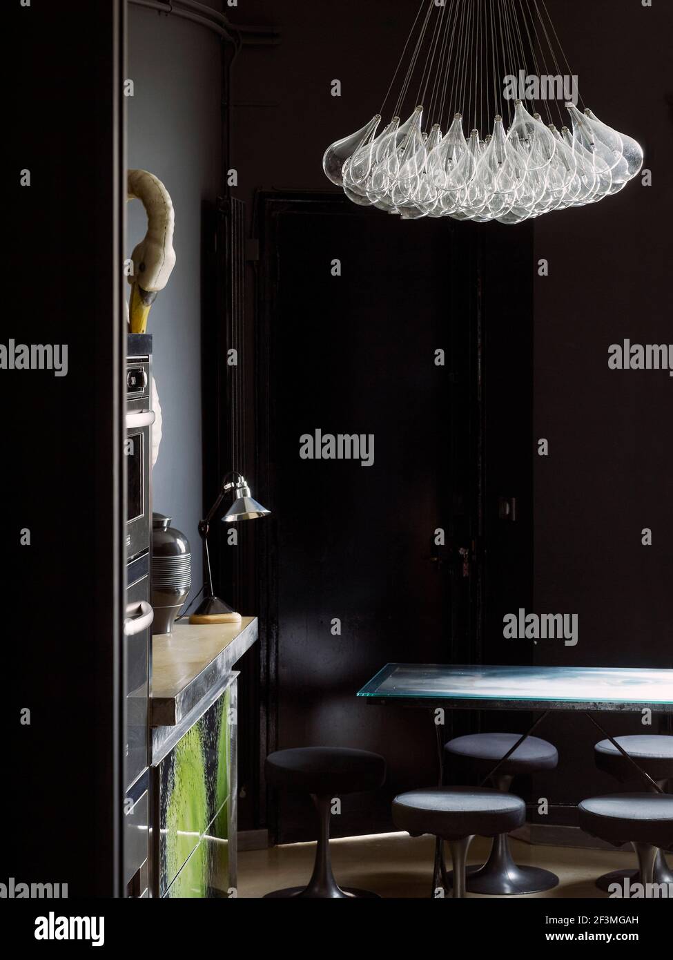 Dining room with designer lighting in French apartment Stock Photo - Alamy