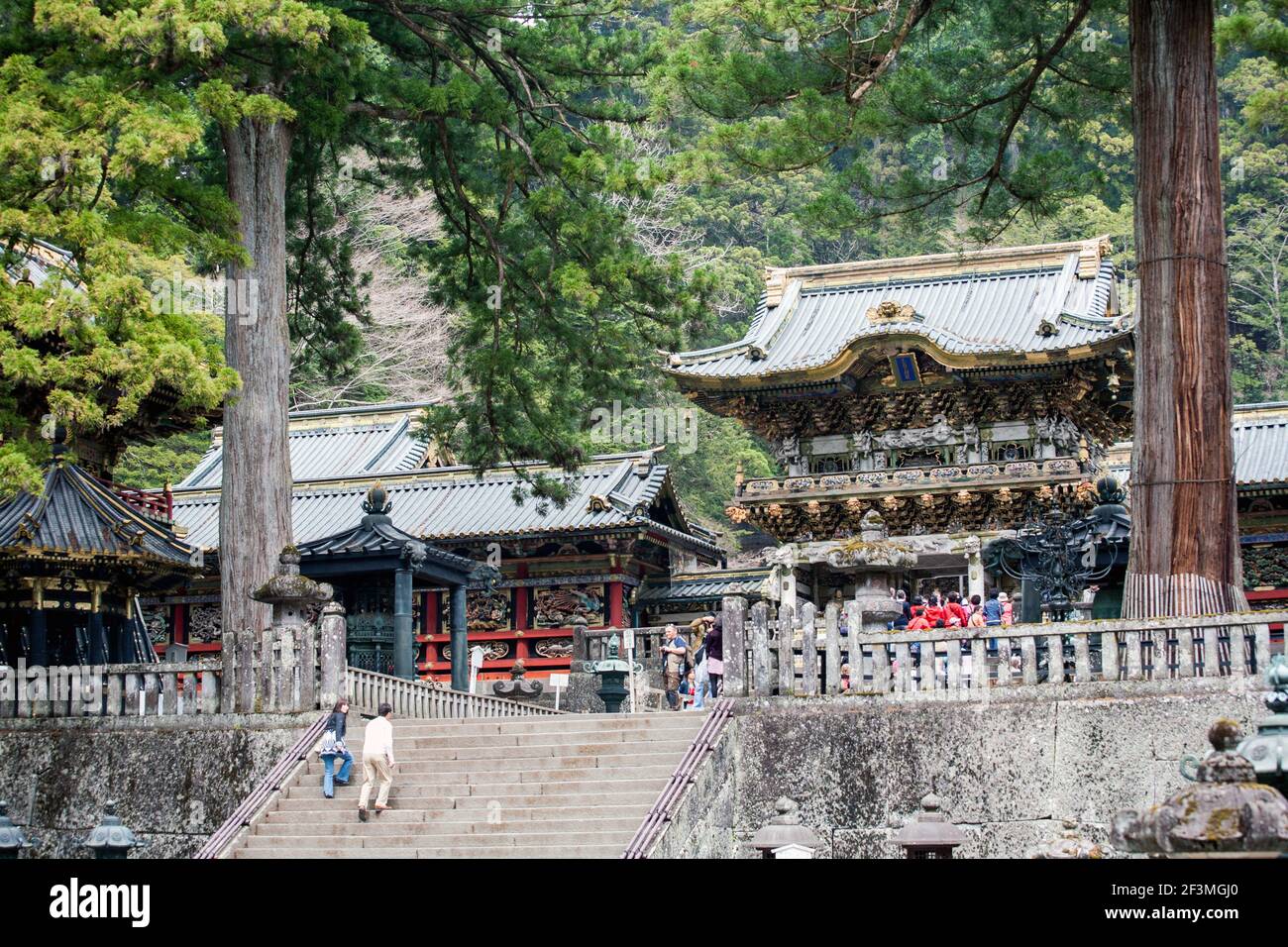 Japanese couple ascending steep steps at Nikko Tosho-gu Shinto Shrine World Heritage Site, Nikko, Japan Stock Photo