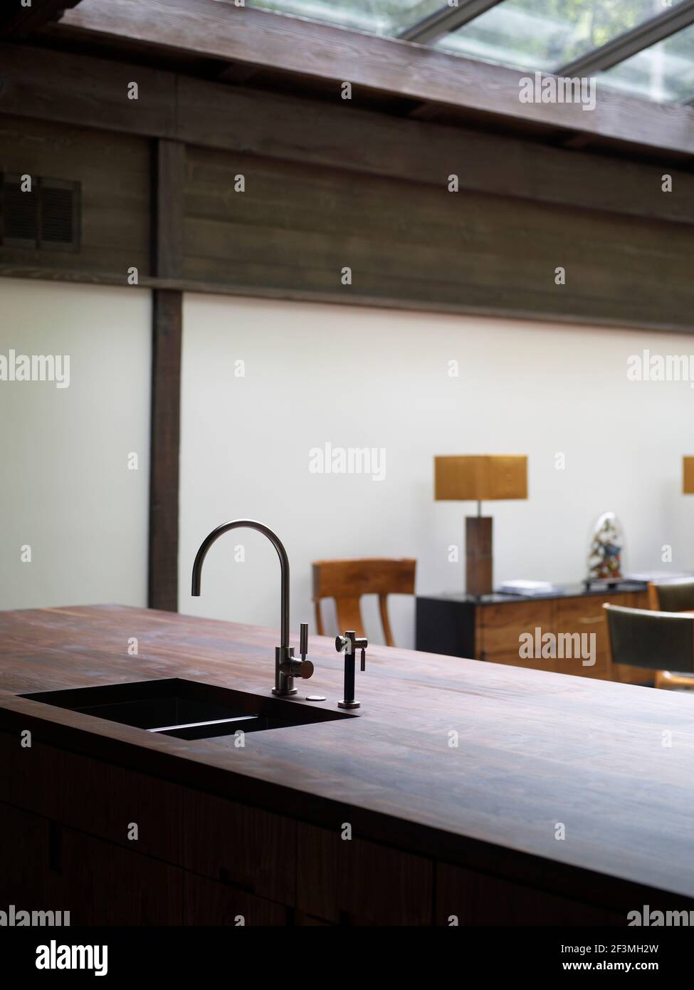 Tap fitting and sink in wooden worktop unit of ranch style California ...
