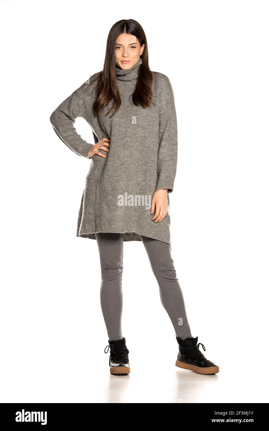 Young beautiful woman in gray tunic on white background Stock Photo