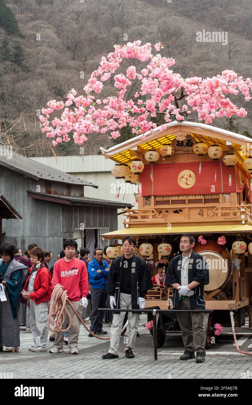 People of Nikko standing beside a hanayatai float celebrating the annual Yayoi Matsuri to celebrate the start of spring, Nikko, Japan Stock Photo