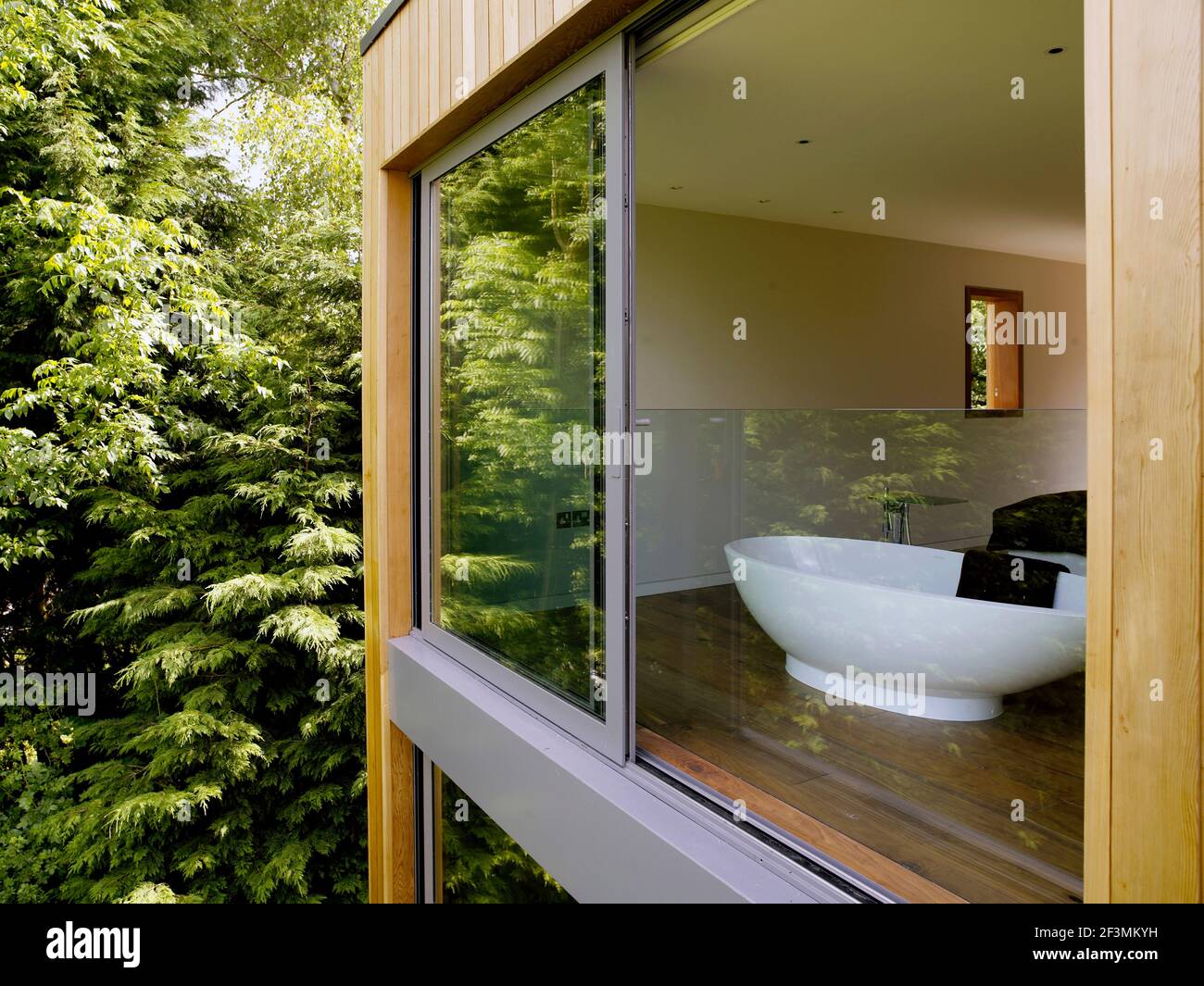 Freestanding bathtub seen through window of UK home Stock Photo