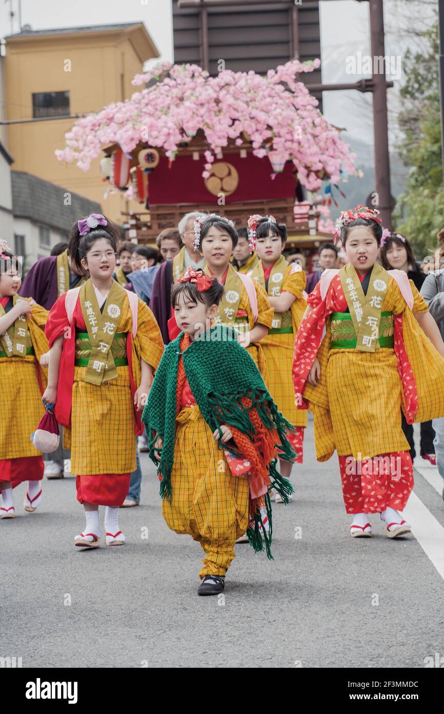 Young Japanese females lead the procession of floats (hanayatais) at the annual Yayoi Matsuri to celebrate the start of spring, Nikko, Japan Stock Photo