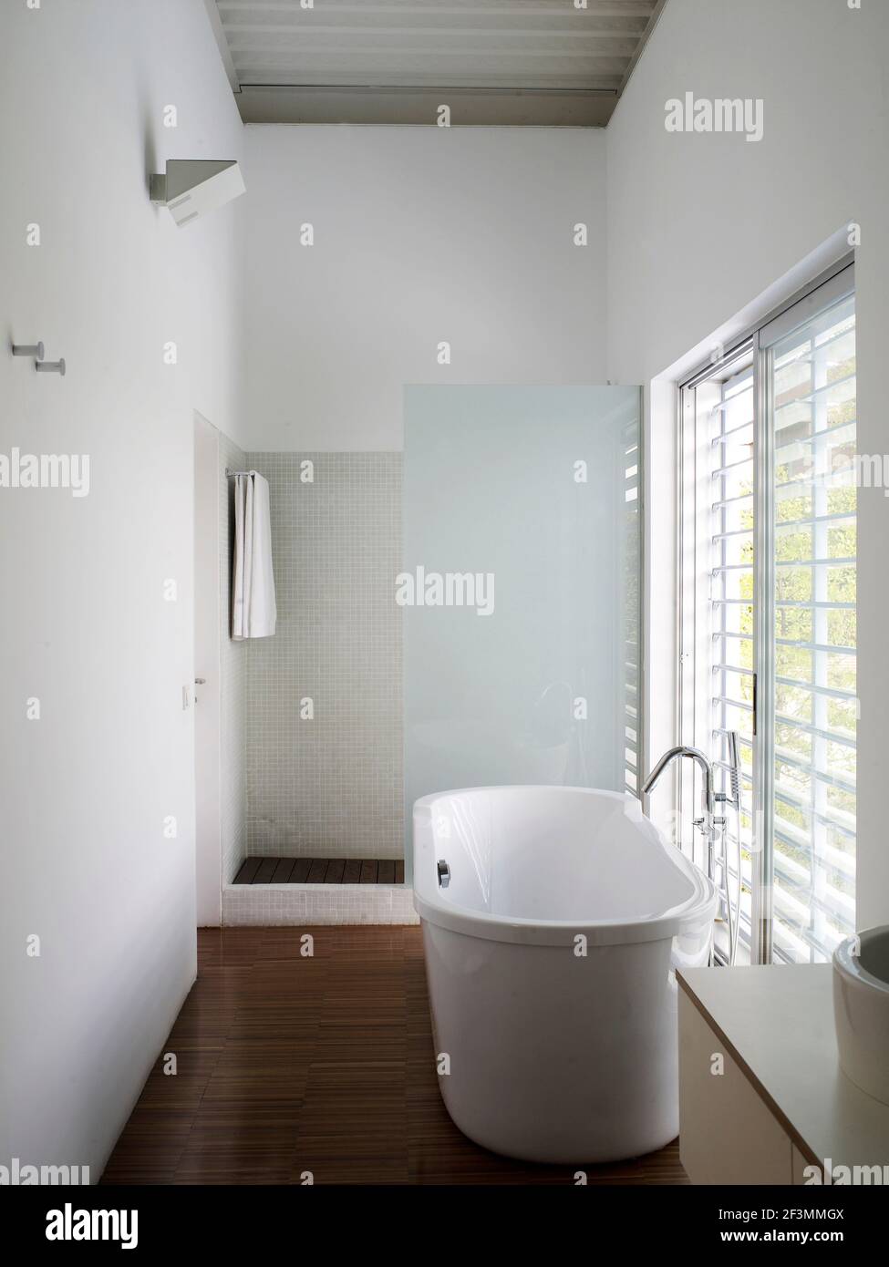 Freestanding bathtub and shower in bathroom in Spanish home Stock Photo