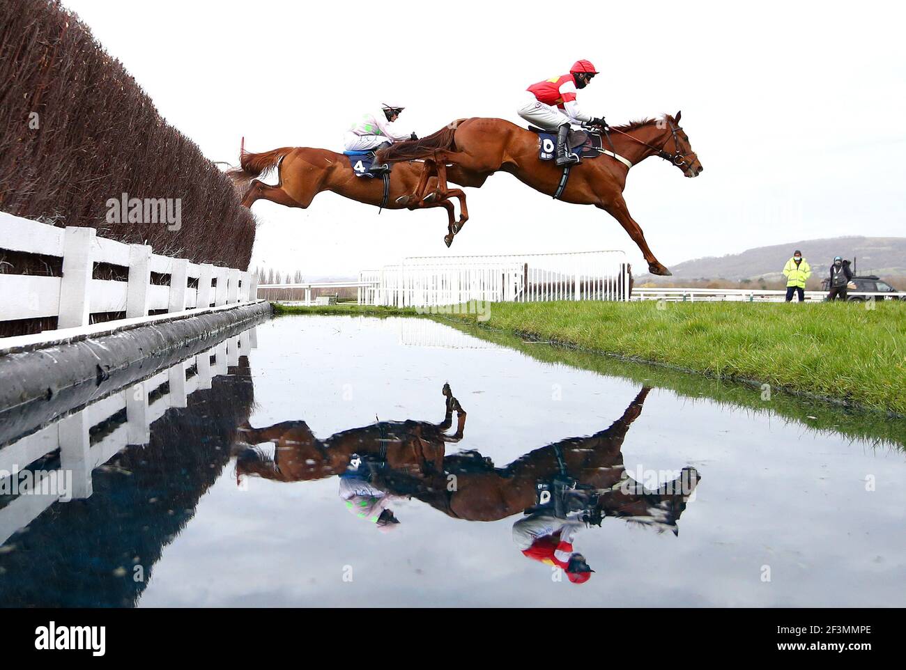 Monkfish (left) ridden by Paul Townend and The Big Breakaway (right) ridden by Harry Cobden jump a water fence during the Brown Advisory Novices' Chase during day two of the Cheltenham Festival at Cheltenham Racecourse. Picture date: Wednesday March 17, 2021. Stock Photo