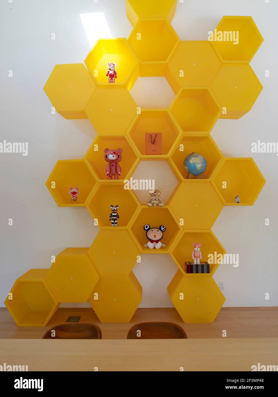 Yellow shaped shelving unit in hallway of USA home Stock