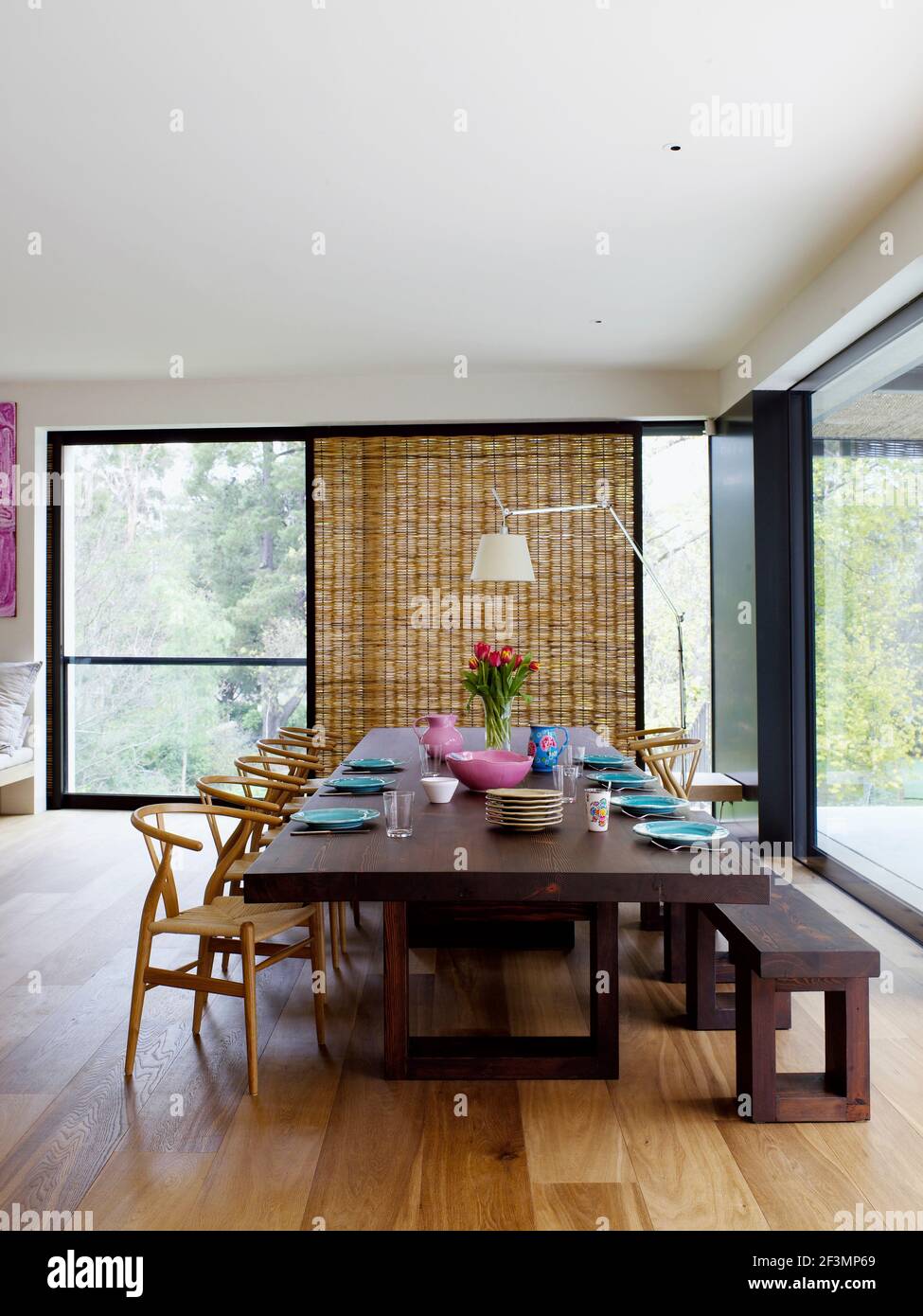 Table and chairs in dining room with wooden floor in Australian home
