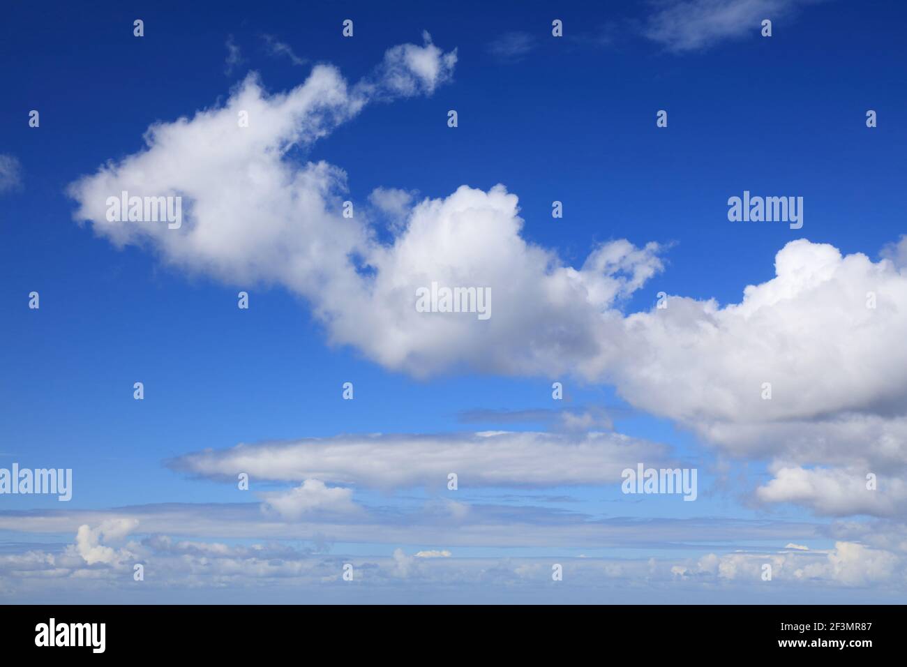 White clouds blue sky background. White cumulus clouds texture. Stock Photo