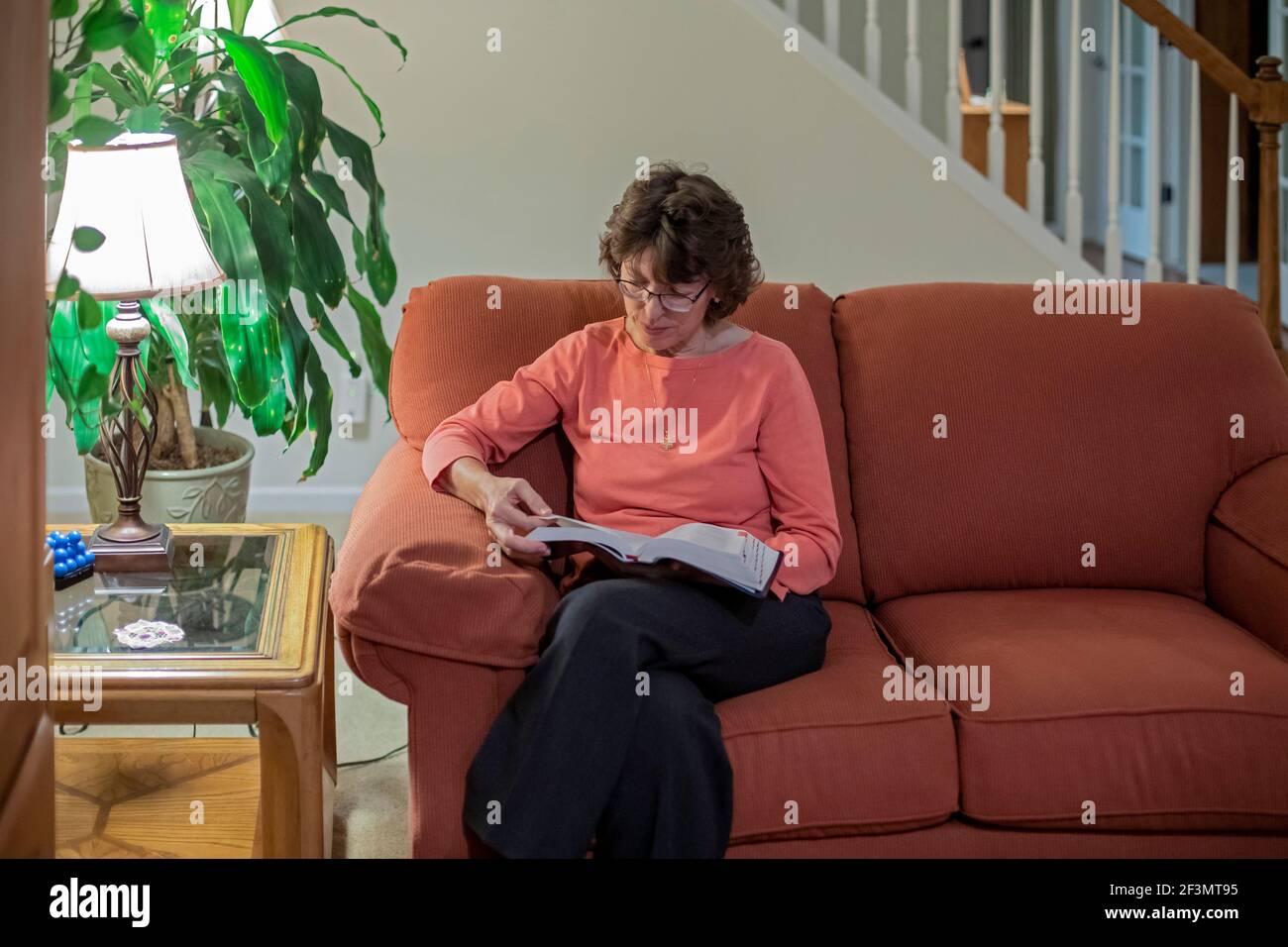 Ypsilanti, Michigan - Dr. Mary Healy reads the Bible at her home. Dr. Healy is professor of Sacred Scripture at Sacred Heart Major Seminary in Detroit Stock Photo