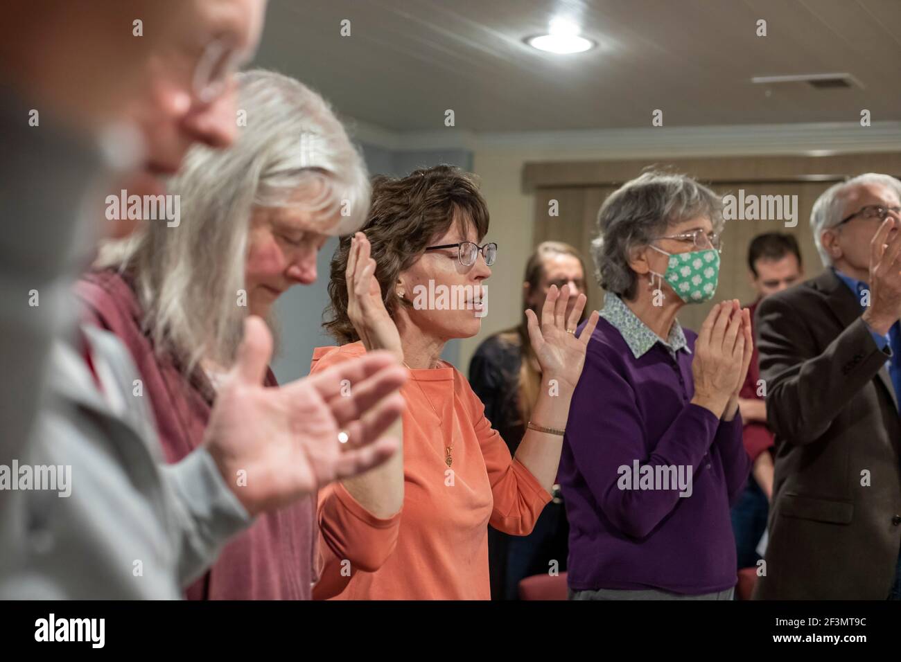 Ypsilanti, Michigan - Dr. Mary Healy (orange top) leads a Catholic prayer group at her home. Dr. Healy is professor of Sacred Scripture at Sacred Hear Stock Photo