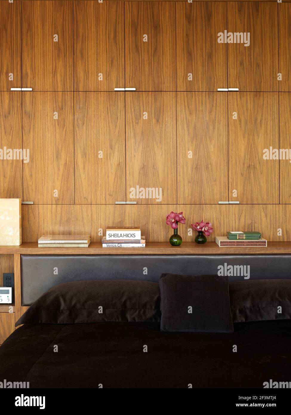 Storage cupboards above double bed in USA home Stock Photo Alamy