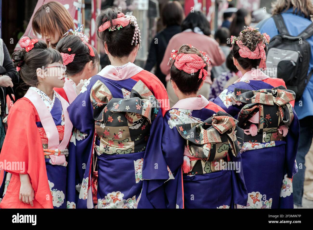 Rear view of young Japanese females dressed in kimonos celebrating the