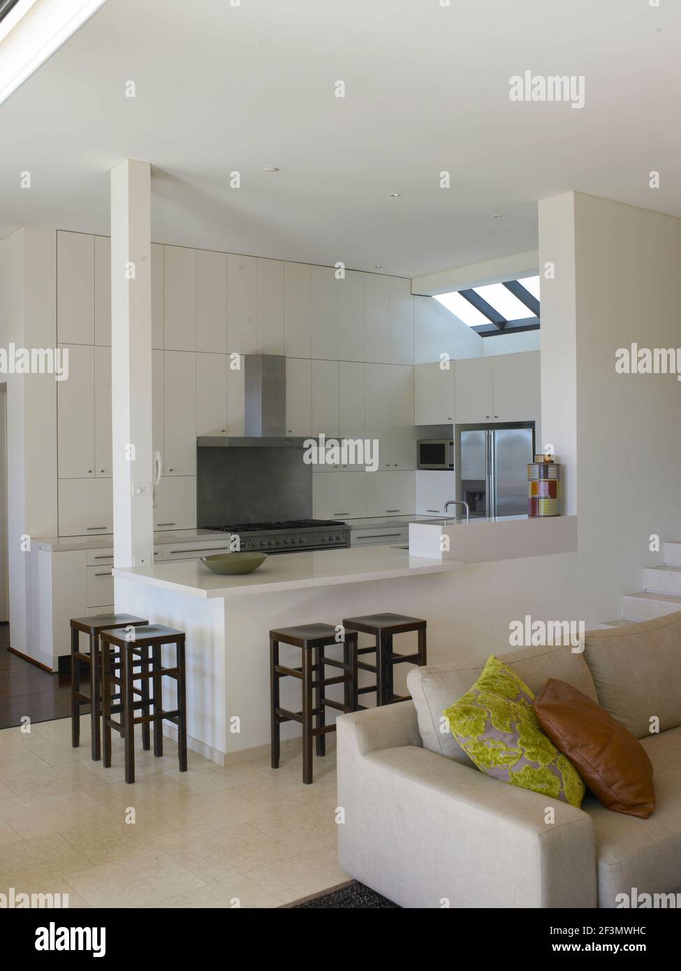 Bar stools at breakfast bar in spacious open plan kitchen, Australia