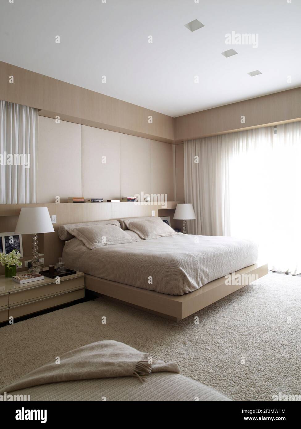 Double bed with built in headboard in bedroom in Brazilian home Stock