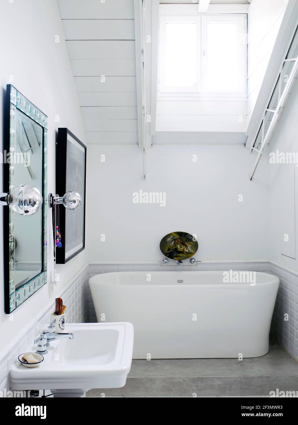 Freestanding bathtub in white bathroom in Spanish home Stock Photo Alamy