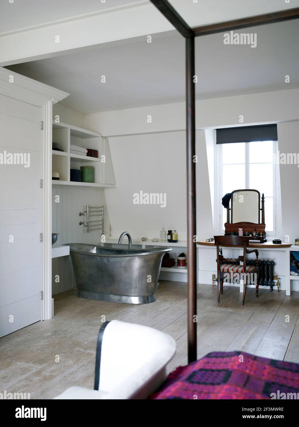Freestanding bathtub in bedroom in UK home Stock Photo Alamy
