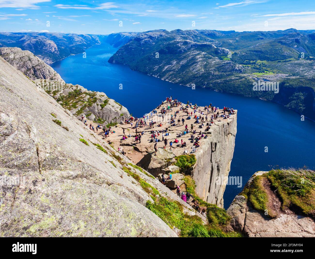 Preikestolen or Prekestolen or Pulpit Rock is a famous tourist attraction near Stavanger, Norway. Preikestolen is a steep cliff which rises above the Stock Photo