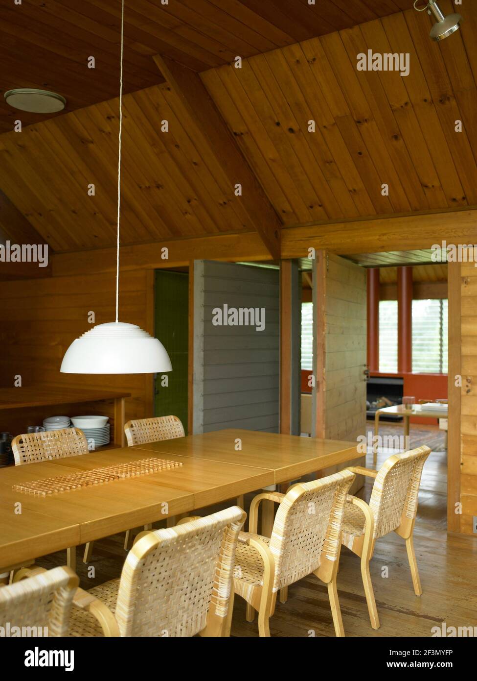 Pendant light above table in wood panelled dining room, Australia Stock Photo - Alamy