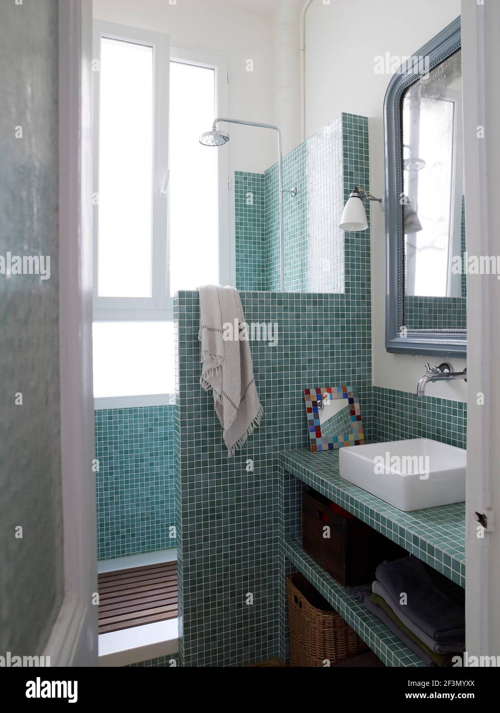 Washbasin in blue tiled bathroom in French home Stock Photo Alamy