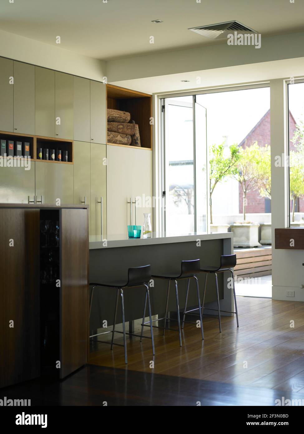 Bar stools at breakfast bar in spacious kitchen in Australian home