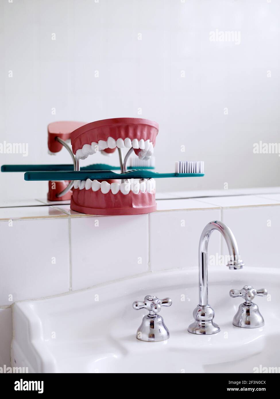Chrome tap fitting over sink in bathroom in Brazilian home Stock Photo