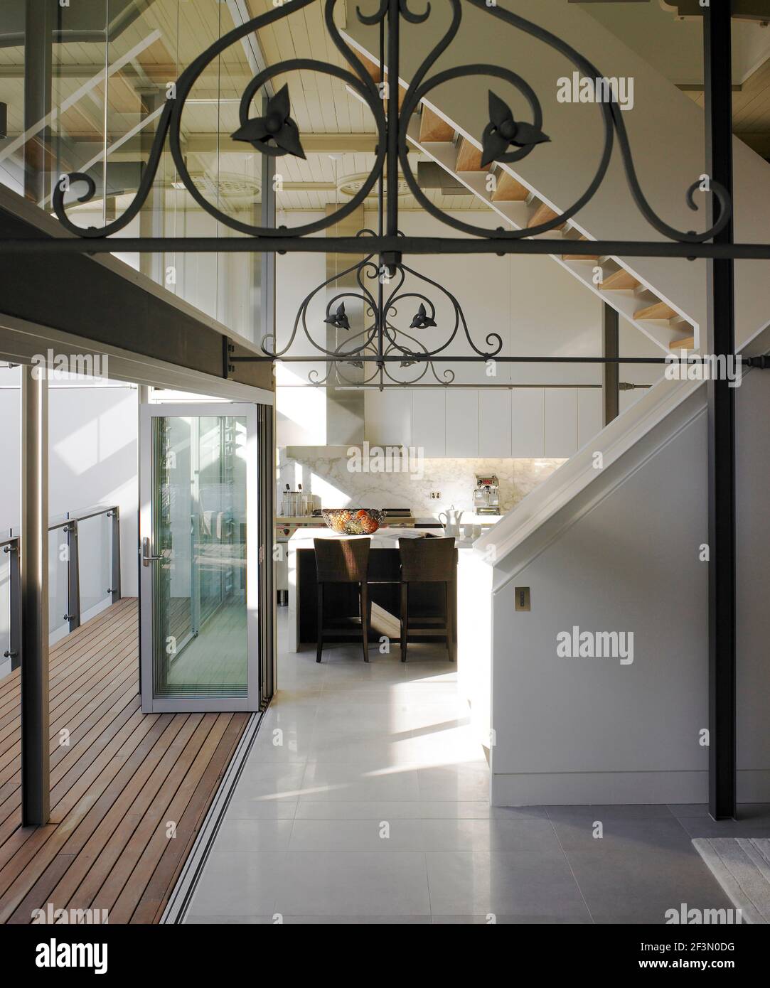 View to kitchen with open door to decked terrace, Australia Stock Photo
