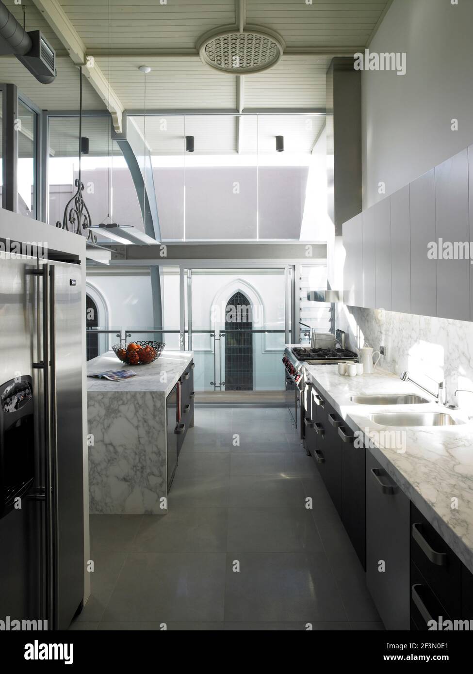 Spacious kitchen with island unit and tiled floor, Australia Stock Photo